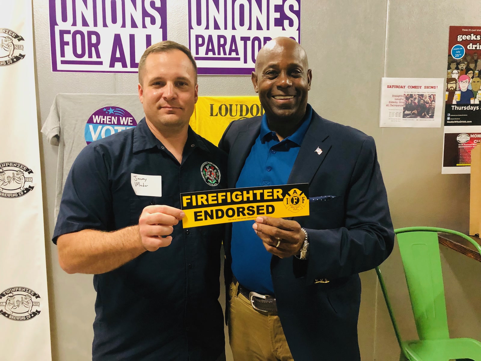 Forest Hayes holding a Firefighter Endorsed sign with a Loudoun firefighter union member