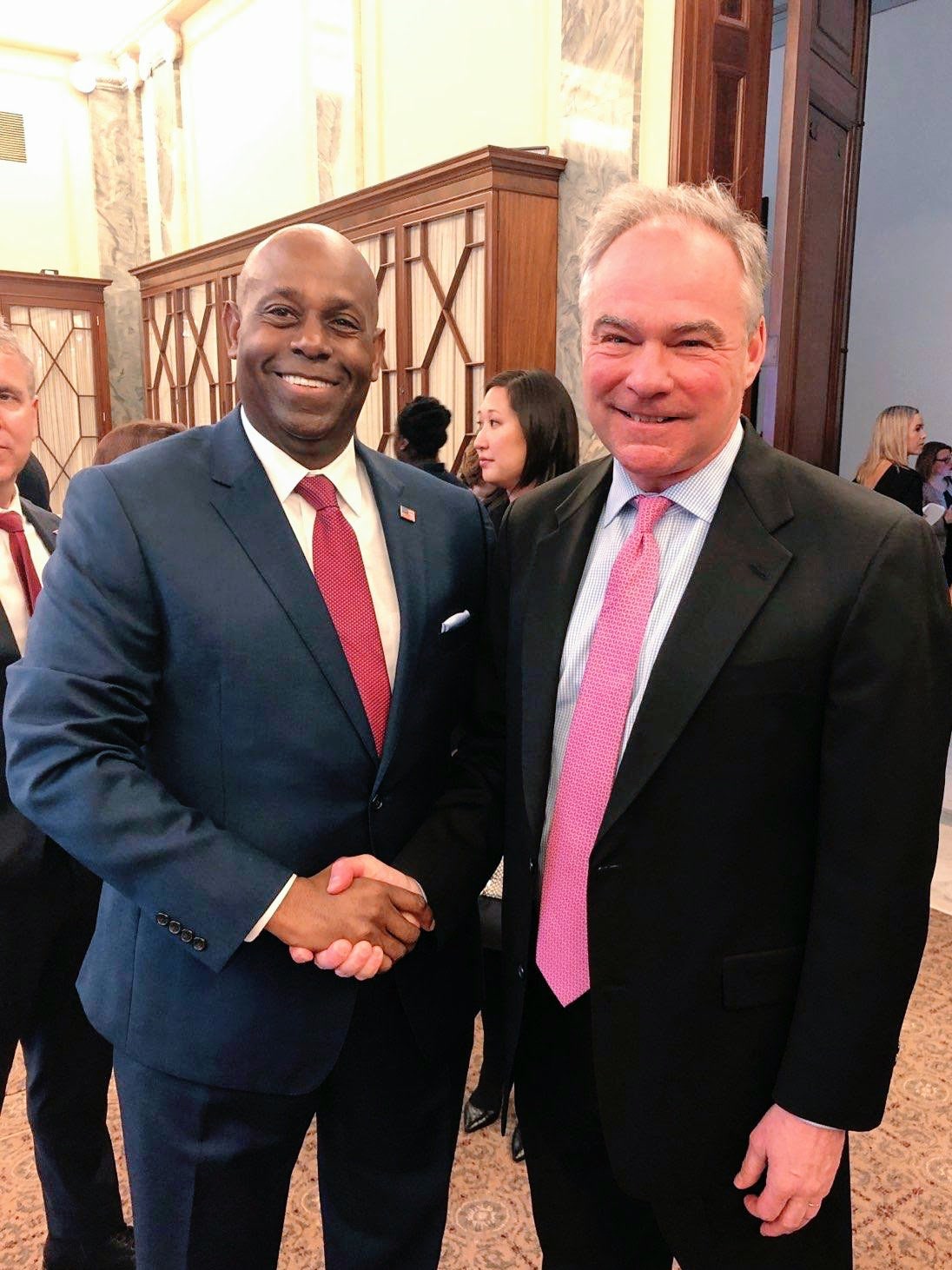 Forest Hayes shaking hands with U.S. Senator Tim Kaine
