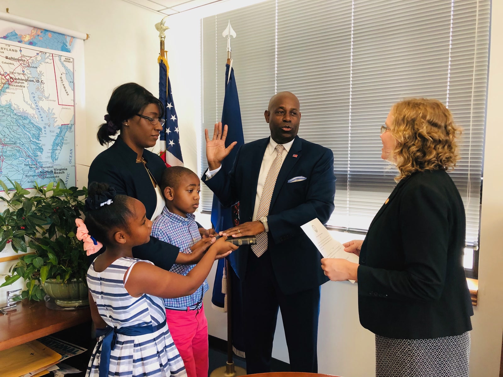 Forest Hayes taking the oath as a Virginia Housing Commissioner, his family holding the Bible