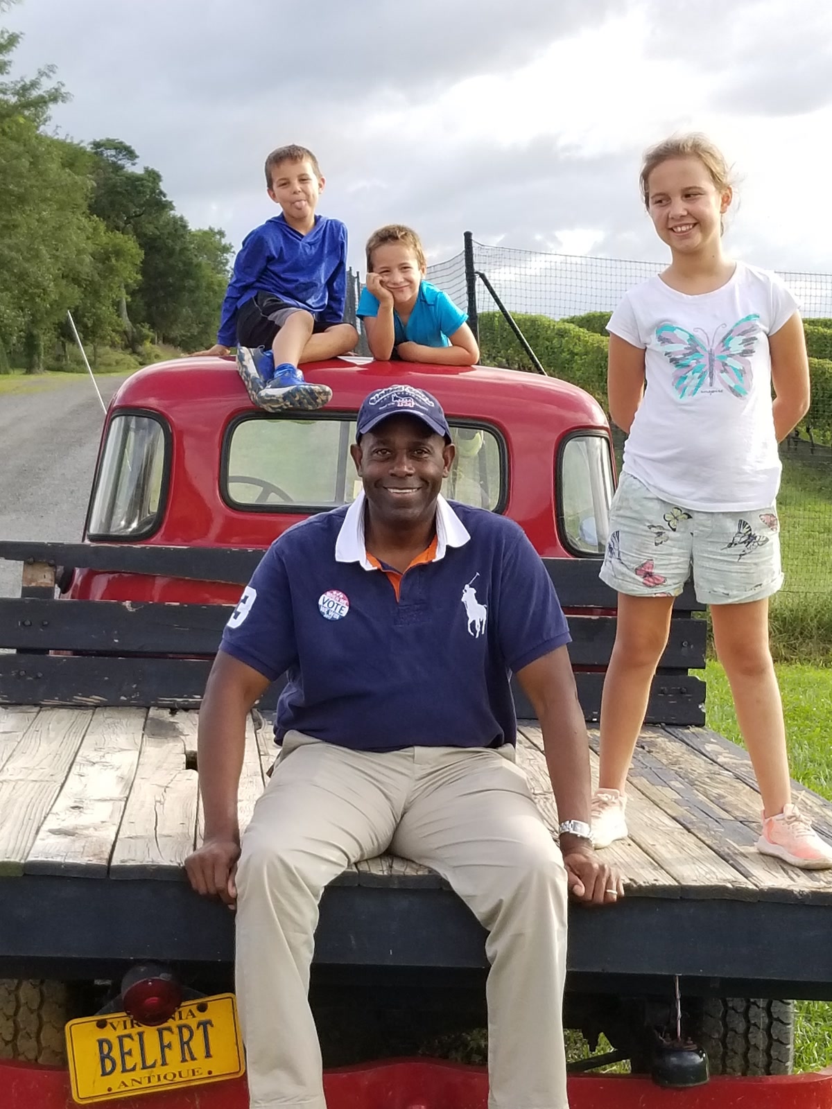 Forest Hayes and neighborhood kids on a vintage red truck