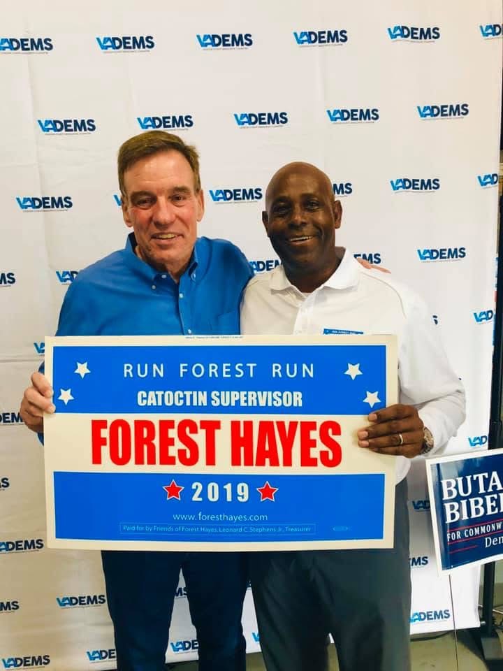 Forest Hayes with U.S. Senator Mark Warner holding a Run Forest Run sign